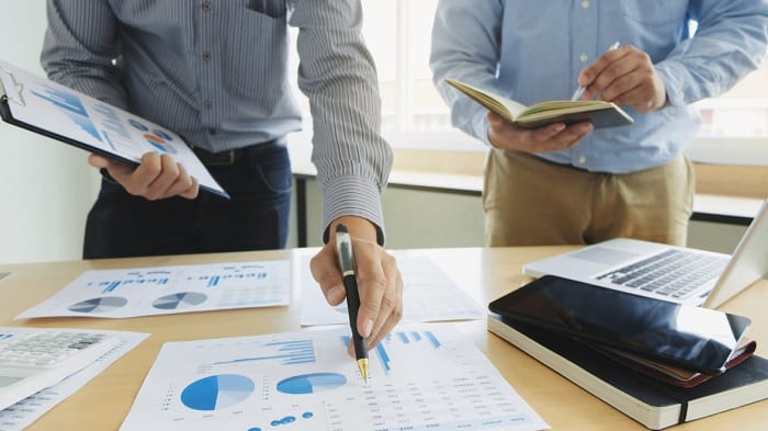 Business executives partner analysis data document with accounta